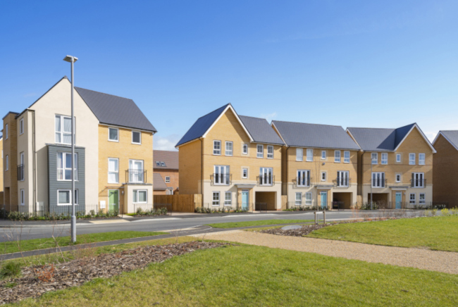 A row of newly built houses on a bright, sunny day.